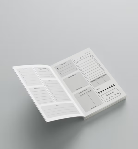 Open planner with various sections on a gray background
